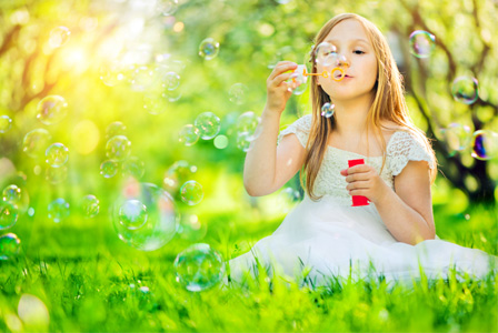 little-girl-blowing-bubbles